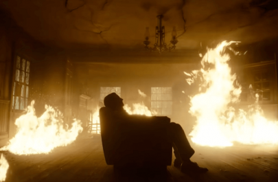 Carlisle-sits-in-a-chair-as-flames-surround-him The Critic's Sanctum