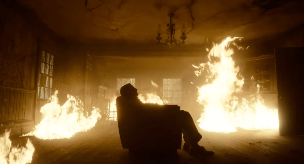 Carlisle sits in a chair as flames surround him The Critics Sanctum