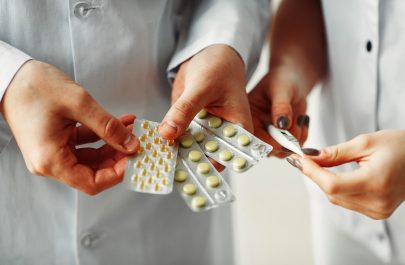 Doctor is sharing pills in hands to another doctor